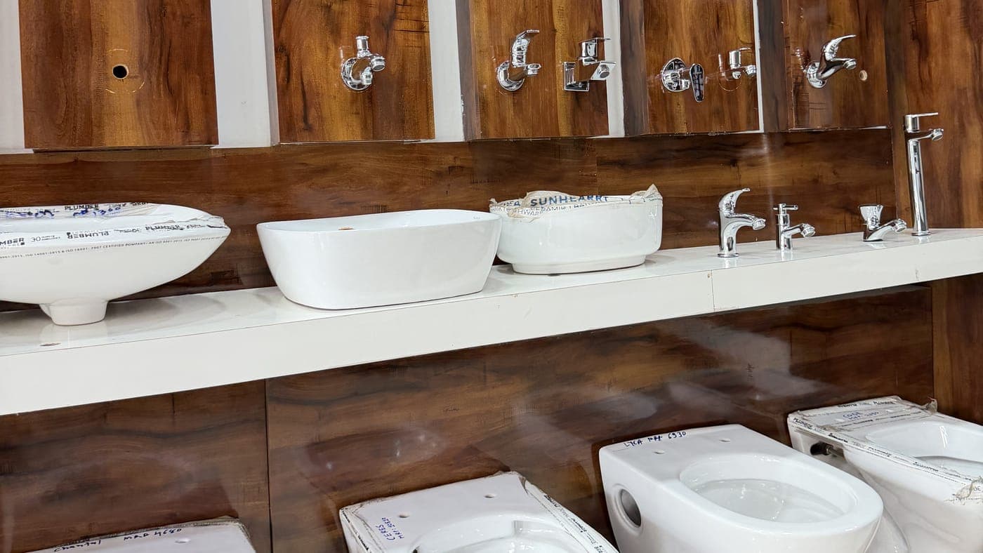 Wash basins, chrome taps and toilets on display in the showroom